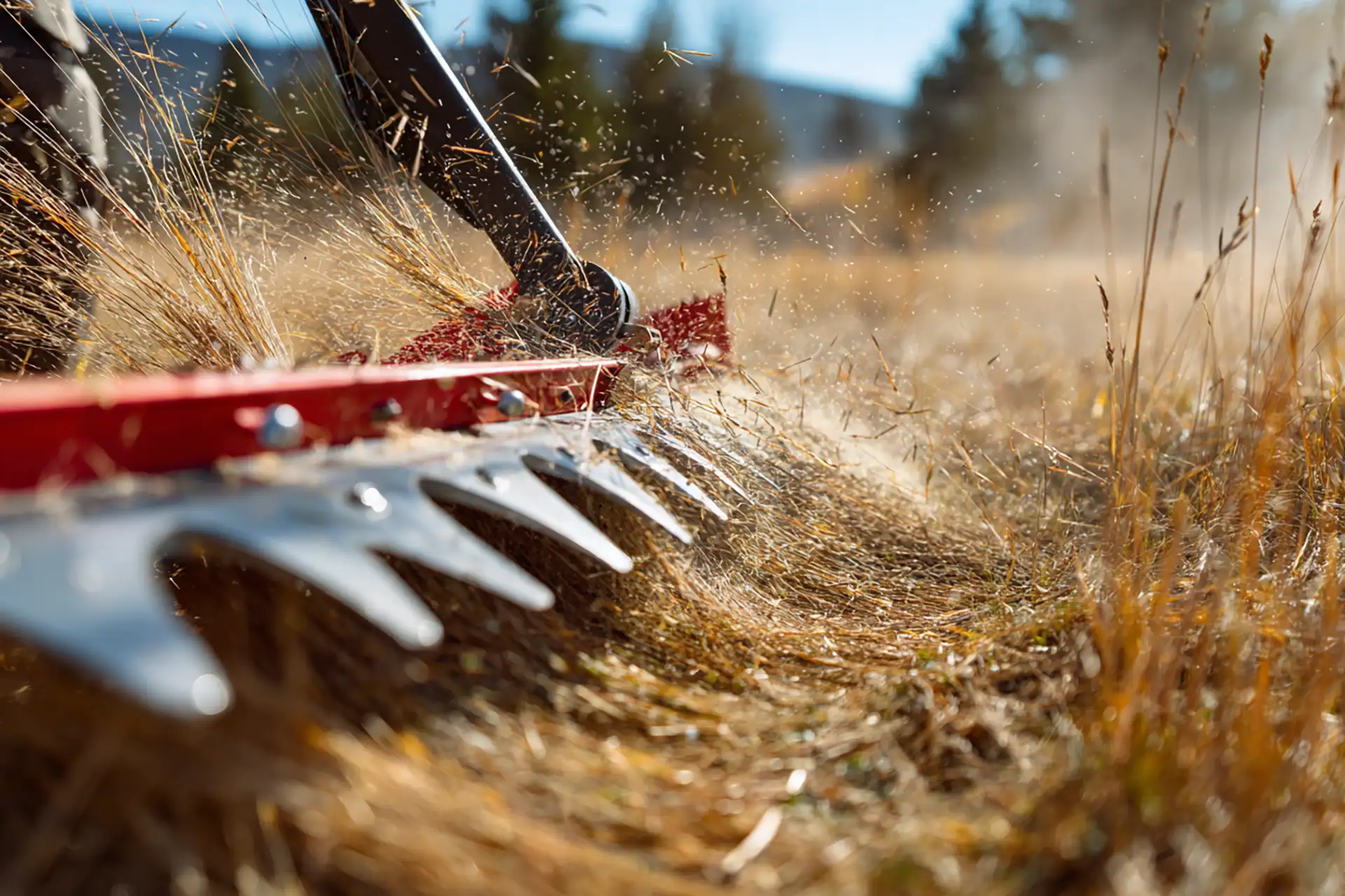 side view of a tractor-mounted sickle bar mowe